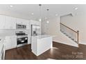 Modern kitchen with white cabinets, stainless steel appliances, and an island at 8603 Mcclure Cir, Charlotte, NC 28216