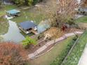 Aerial view of waterfront property, featuring a private dock and landscaped yard with mature trees at 271 Lockhard Cir, Troutman, NC 28166