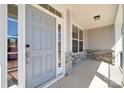 Covered porch and a gray front door with sidelight and decorative stone base at 117 Jentri Way, Mooresville, NC 28115