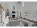 Cozy living room features a fireplace, high ceiling, lots of windows and neutral decor at 5303 Shasta Hill Ct, Charlotte, NC 28211
