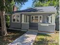 Charming gray home with a covered front porch and a brick chimney at 602 W Council St, Salisbury, NC 28144