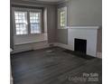 Inviting living room featuring new flooring, fireplace, and abundant natural light at 602 W Council St, Salisbury, NC 28144