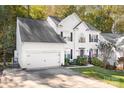 Two-story house with white siding, black shutters, and a long driveway at 112 Sugar Thyme Ln, Mooresville, NC 28115