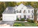 White two-story house with black shutters, landscaping, and a front porch at 112 Sugar Thyme Ln, Mooresville, NC 28115