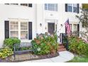 Inviting front entrance with brick steps, lush hydrangeas, and a black bench at 112 Sugar Thyme Ln, Mooresville, NC 28115