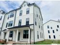 Two-story exterior showcasing the modern farmhouse design and well-manicured lawn at 12126 Storm Ln # 53, Charlotte, NC 28277