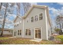 Back exterior view of townhome featuring slider glass doors and many windows at 9247 Eleanor Dr, Charlotte, NC 28214