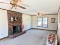 Spacious living room featuring a brick fireplace and large windows at 2304 Fox Hunt Dr, Monroe, NC 28110