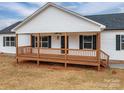 Charming home with a classic covered front porch, wooden decking, and black shutters at 9303 Reepsville Rd, Vale, NC 28168
