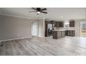 Open-concept living area with seamless flow between the kitchen and living room; featuring modern light wood floors at 9303 Reepsville Rd, Vale, NC 28168