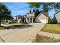 Charming two-story home with a manicured lawn and a two-car garage on a sunny day at 535 Red Wolf Ln, Lake Wylie, SC 29710