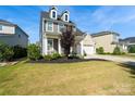 Charming two-story home with a manicured lawn and a two-car garage on a sunny day at 535 Red Wolf Ln, Lake Wylie, SC 29710