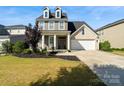 Charming two-story home with a manicured lawn and a two-car garage on a sunny day at 535 Red Wolf Ln, Lake Wylie, SC 29710