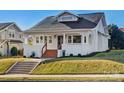 Charming bungalow with white exterior, updated landscaping, and a welcoming front porch at 103 2Nd Nw Ave, Hickory, NC 28601