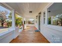 Inviting front porch with wooden flooring and white columns at 103 2Nd Nw Ave, Hickory, NC 28601