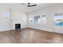 Bright living room with hardwood floors, a fireplace, and large windows at 103 2Nd Nw Ave, Hickory, NC 28601