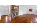 Living room with hardwood floors and brick fireplace at 1727 Hartford Dr, Gastonia, NC 28052