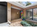 Front entry with geometric glass door and brick accents at 423 Whitestone Rd, Charlotte, NC 28270