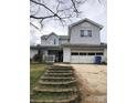 Two-story house with attached garage and stone steps at 8540 Indian Summer Trl, Harrisburg, NC 28075