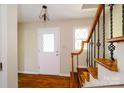 Bright foyer with hardwood floors and decorative staircase, creating a welcoming entry space at 1018 Carysbrook Ln, Charlotte, NC 28217