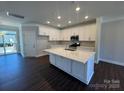 Bright kitchen with white cabinets, quartz countertops, stainless steel appliances, and hardwood floors at 5540 Stafford Rd # 31, Charlotte, NC 28215