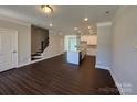 Spacious living area with an island kitchen, hardwood floors, stairs and a large window at 5540 Stafford Rd # 31, Charlotte, NC 28215
