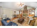 Cozy living room boasts a stone fireplace, built-in shelves, and plush seating at 15450 Millview Trace Ln, Mint Hill, NC 28227