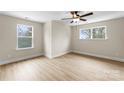 Bright, spacious bedroom with luxury vinyl flooring, a ceiling fan, and natural light at 1914 Irma St, Charlotte, NC 28216