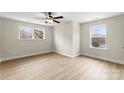 Bright, spacious bedroom with luxury vinyl flooring, a ceiling fan, and natural light at 1914 Irma St, Charlotte, NC 28216