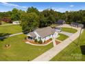 Charming white farmhouse with a welcoming front porch, surrounded by mature trees and a long driveway at 5070 Woodleaf Rd, Salisbury, NC 28147