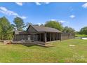 Metal building exterior with covered patio and fire pit area at 5070 Woodleaf Rd, Salisbury, NC 28147