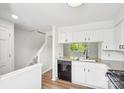 Bright kitchen features white cabinets, granite countertops and black appliances at 9424 Lexington Cir # F, Charlotte, NC 28213
