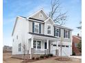 Two-story house with white and gray siding, a metal roof, and a two-car garage at 2304 Catalina Ave, Charlotte, NC 28206