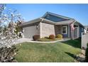 Beautiful home showcasing a brick facade, well-manicured lawn, and an American flag out front at 6296 Raven Rock Dr # 725, Denver, NC 28037