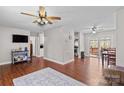 Open living room with hardwood floors and access to kitchen at 797 Chief Thomas Rd, Harmony, NC 28634