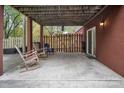 Covered patio area featuring a sliding glass door, lighting, a fenced area, and outdoor seating at 914 Wyke Rd, Shelby, NC 28150