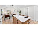 Modern kitchen island with seating, white cabinets and quartz countertops at 2443 Myrtle Ave, Gastonia, NC 28052