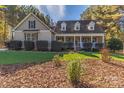 Beautiful home with a covered front porch, well-manicured lawn, and attractive landscaping at 360 Lauren Pines Dr, York, SC 29745