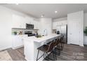 Modern white kitchen with island, stainless steel appliances, and hardwood floors at 362 Brinkley Dr # 142, Kings Mountain, NC 28086