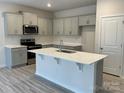 Modern kitchen with gray cabinets, white countertops, and island at 404 Brinkley Dr # 141, Kings Mountain, NC 28086