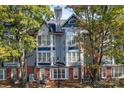 Gray building exterior with blue accents and landscaping at 513 N Graham St # 3D, Charlotte, NC 28202