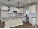 Modern kitchen featuring white cabinets, granite countertops, and stainless steel appliances at 723 E Memorial Hwy, Harmony, NC 28634