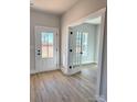 Bright entryway with hardwood floors and French doors leading to an office at 737 E Memorial Hwy, Harmony, NC 28634