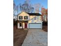 Two-story home with white siding, black accents, and a red front door at 737 E Memorial Hwy, Harmony, NC 28634