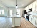 Modern kitchen with white cabinets, granite counters, and stainless steel appliances at 737 E Memorial Hwy, Harmony, NC 28634