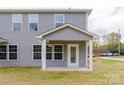 Gray two-story home with gray siding, a back door with a porch and a lawn at 2014 Crown Point Dr # 2008-B, Albemarle, NC 28001