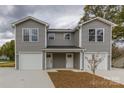 New gray townhome offers a front-entry two-car garage and covered front porch at 2014 Crown Point Dr # 2008-B, Albemarle, NC 28001