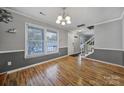 Light-filled dining area with hardwood floors and access to stairs at 6934 Spring Morning Ln, Charlotte, NC 28227