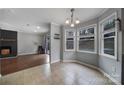 Eat-in kitchen with tiled floor, bay window, and dark cabinets at 6934 Spring Morning Ln, Charlotte, NC 28227