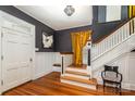 Grand entryway with hardwood floors, beautiful stairs, and decorative lighting fixture at 70 Spring Nw St, Concord, NC 28025